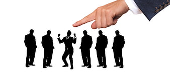 Hand pointing at selected business silhouette from group