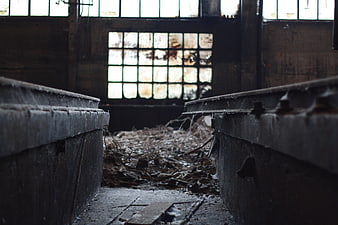 Abandoned Industrial Interior with Rusty Metal Beams and Debris