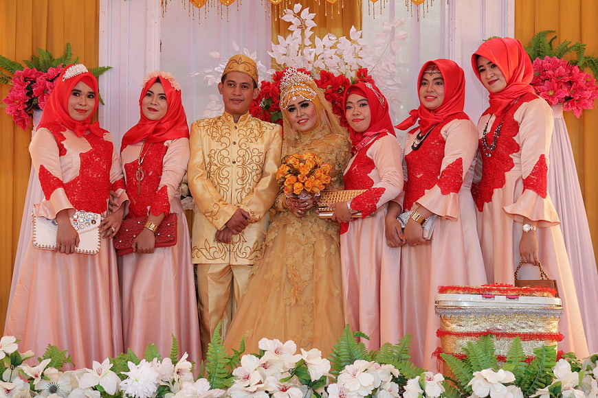 Traditional Indonesian Wedding Party in Gold and Red Attire