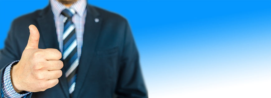 Businessman giving thumbs up on blue background