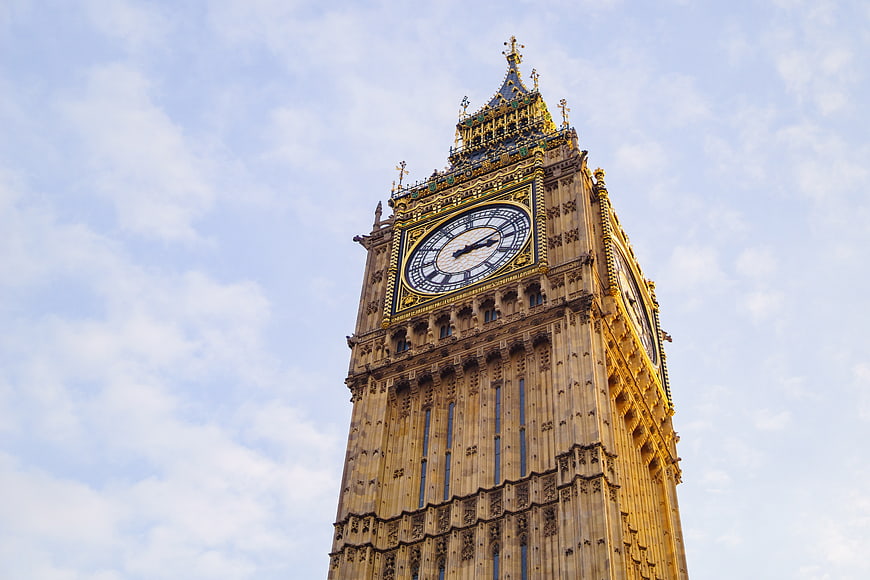 Low angle view of Big Ben clock tower against blue sky