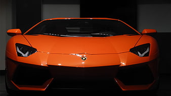 Front View of Orange Lamborghini Aventador in Dark Studio