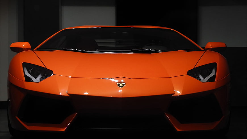 Front View of Orange Lamborghini Aventador in Dark Studio