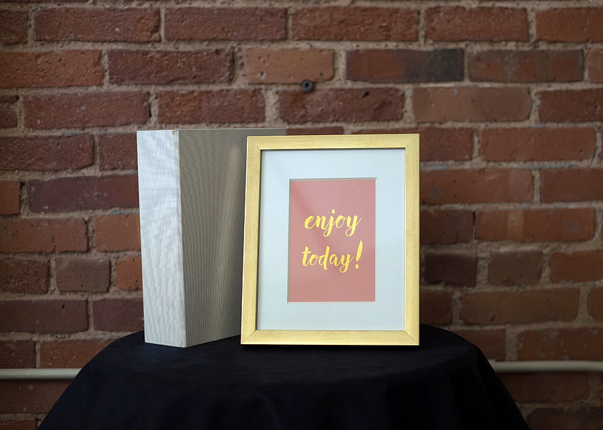 Framed 'Enjoy Today' Quote on Brick Wall Background