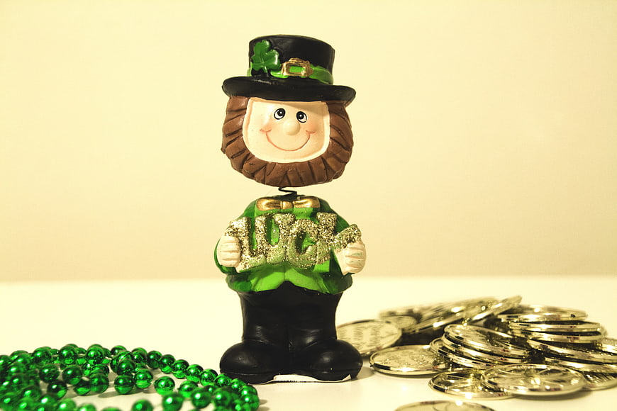 Leprechaun Figurine Holding Lucky Sign With Green Beads And Coins