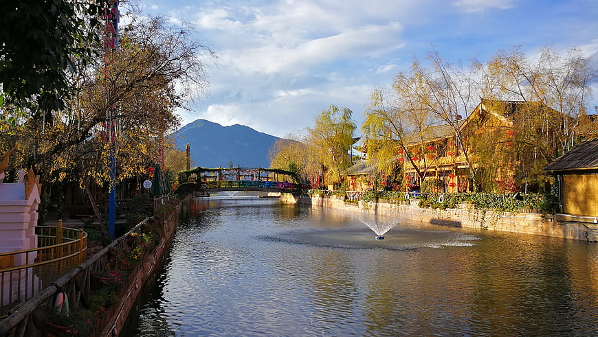 Scenic River Canal with Bridge and Traditional Buildings in Autumn