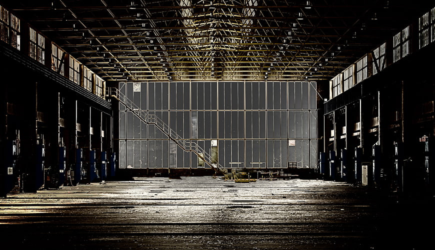 Dark Abandoned Industrial Factory Hall Interior With Dramatic Lighting