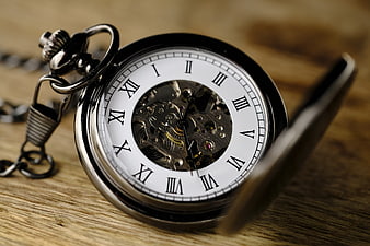 Vintage Skeleton Pocket Watch on Wooden Surface