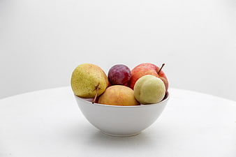 Minimalist White Bowl of Fresh Assorted Fruit