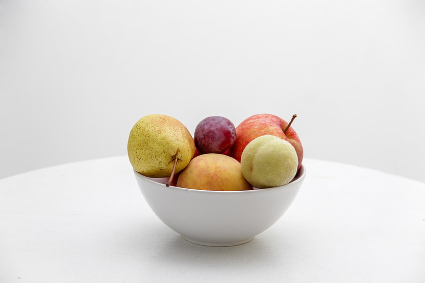 Minimalist White Bowl of Fresh Assorted Fruit