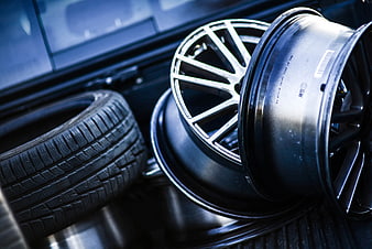 Close-up of car rims and tire in vehicle trunk