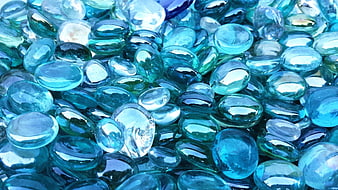 Close-up of shiny blue glass pebbles and gemstones texture