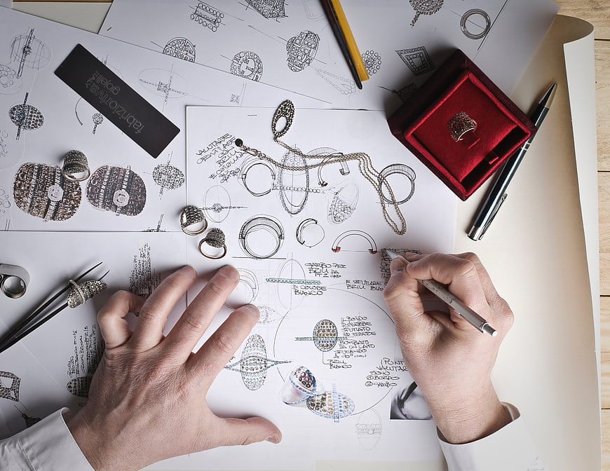 Jewelry designer sketching ring designs on paper