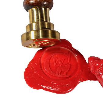 Brass wax seal stamp pressing red wax with custom logo