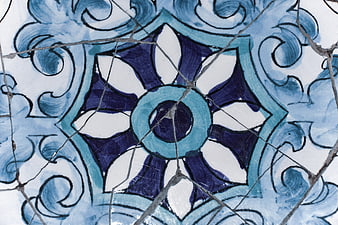 Close-up of cracked blue and white ceramic tile pattern