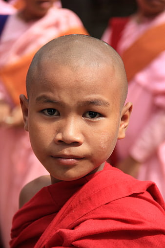 Portrait of Young Buddhist Monk in Red Robe
