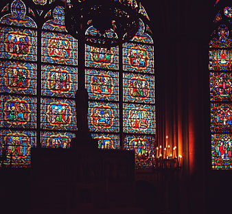 Gothic Stained Glass Windows and Candles in Cathedral Interior