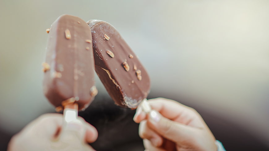 Two Hands Holding Chocolate Ice Cream Bars