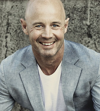 Portrait of Smiling Bald Man in Blue Blazer