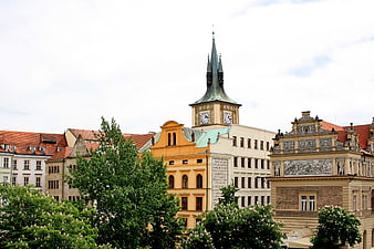 Historic Prague Architecture with Clock Tower and Green Trees