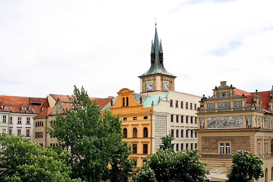 Historic Prague Architecture with Clock Tower and Green Trees