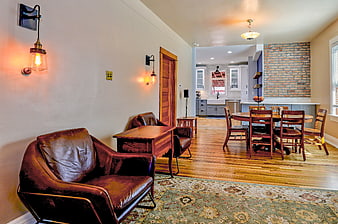 Modern Interior with Leather Sofa, Dining Table, and Exposed Brick