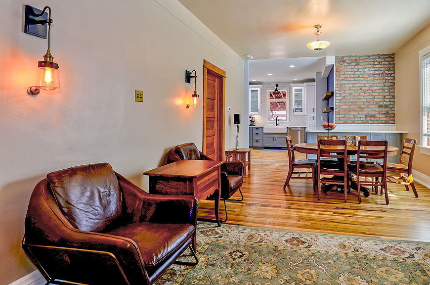 Modern Interior with Leather Sofa, Dining Table, and Exposed Brick
