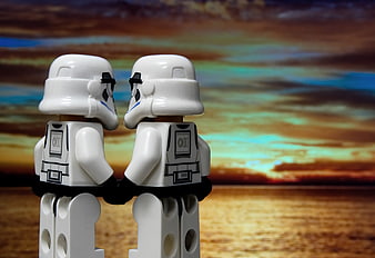 Two Lego Stormtroopers Holding Hands Against a Dramatic Sunset Sky