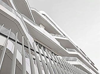 Modern white curved building facade with vertical slats