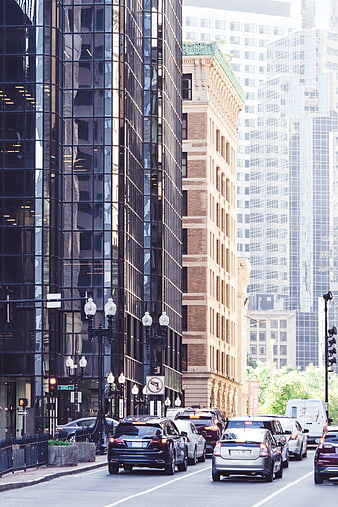 Urban street traffic with modern and historic skyscrapers