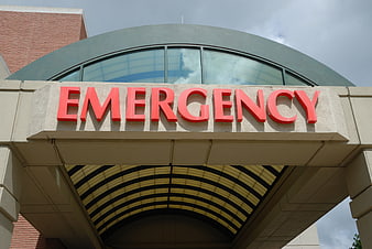 Red Emergency Sign on Hospital Entrance Canopy
