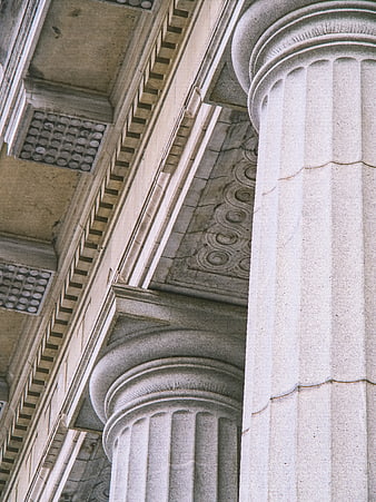 Low angle view of classical stone columns and ornate architectural details