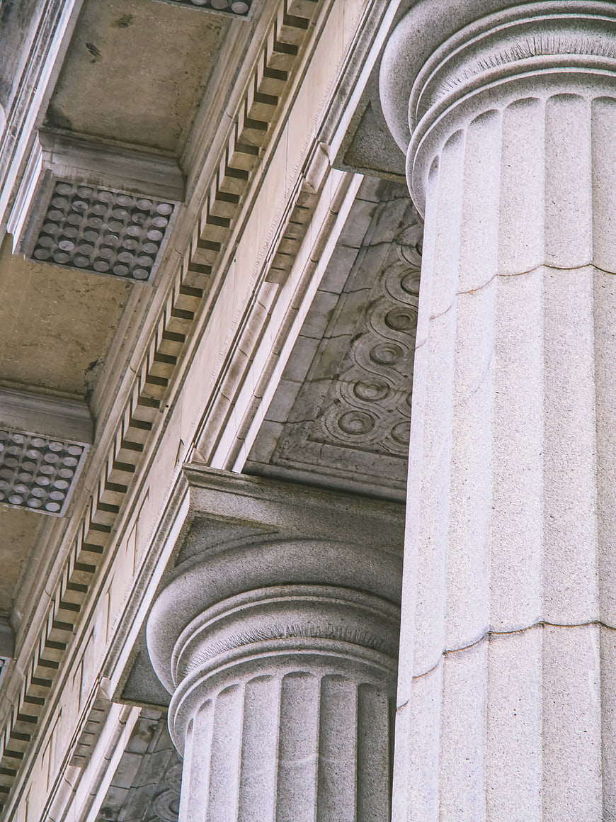 Low angle view of classical stone columns and ornate architectural details