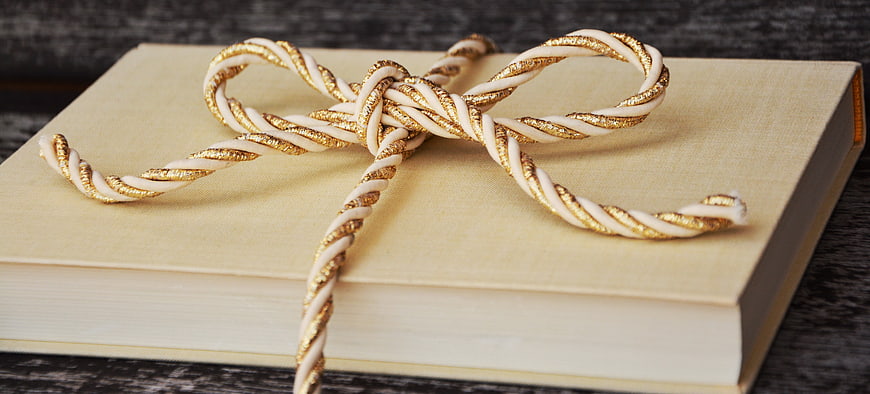 Beige Book Wrapped with Gold and White Twisted Ribbon