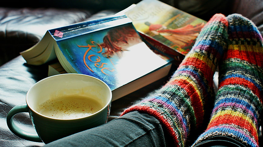 Cozy Reading Scene With Coffee And Colorful Socks
