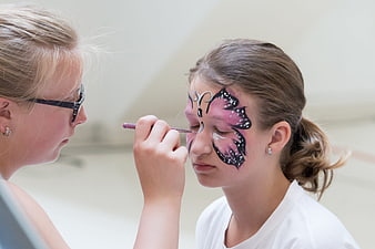 Girl Getting Butterfly Face Painted by Artist