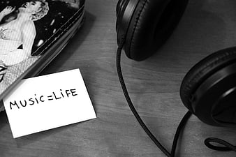 Black and white headphones with music equals life note