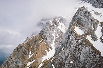 Dramatic Rocky Mountain Ridge with Snow and Clouds