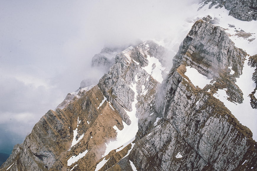 Dramatic Rocky Mountain Ridge with Snow and Clouds