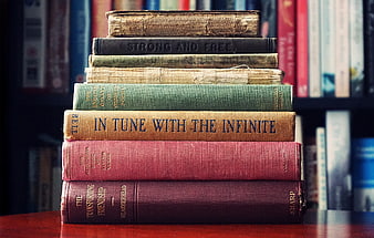 Stack of vintage books on wooden table