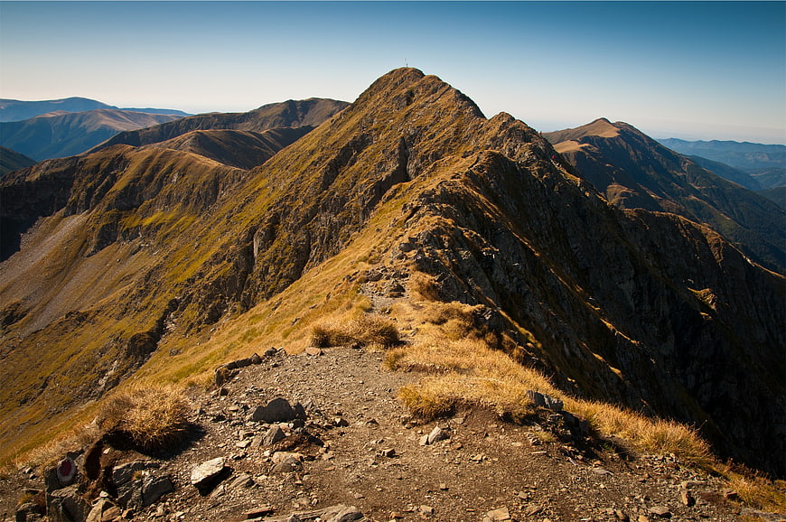 Rugged Mountain Ridge Trail with Golden Grass and Blue Sky