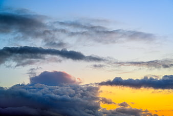 Dramatic sunset sky with layered clouds and golden light