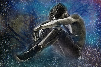 Sad shirtless man sitting in mystical blue fantasy background