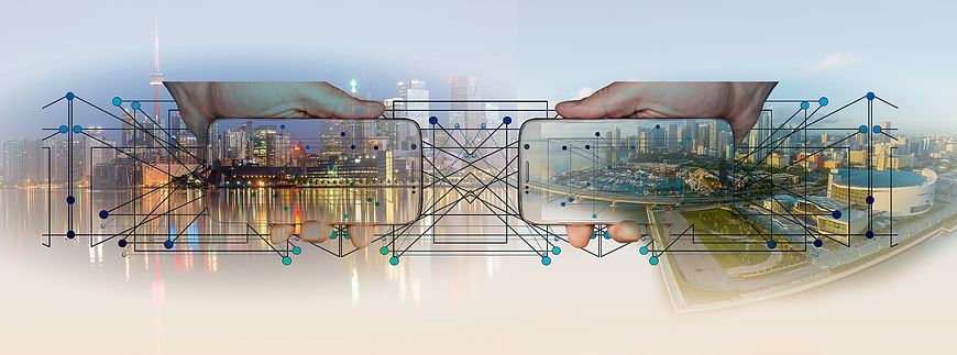Smartphones displaying cityscape with digital network overlay