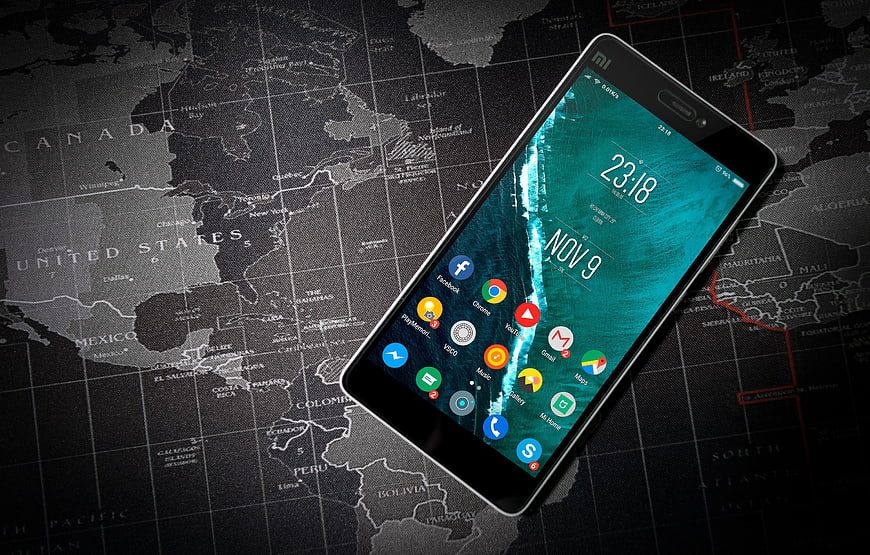 Smartphone on Vintage World Map Background