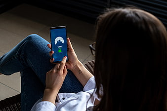 Woman using VPN app on smartphone for internet security