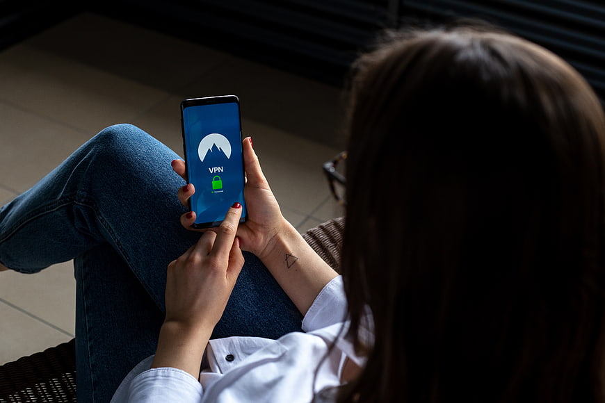 Woman using VPN app on smartphone for internet security