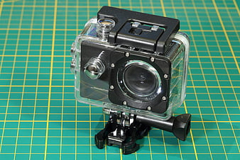Waterproof Action Camera in Clear Housing on Green Cutting Mat