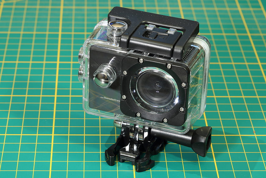 Waterproof Action Camera in Clear Housing on Green Cutting Mat