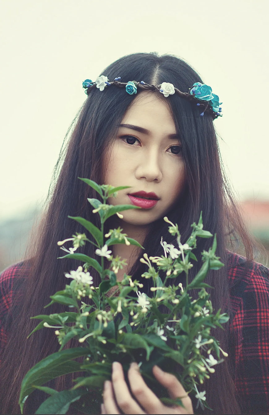 Woman with Flower Crown Holding White Blossoms